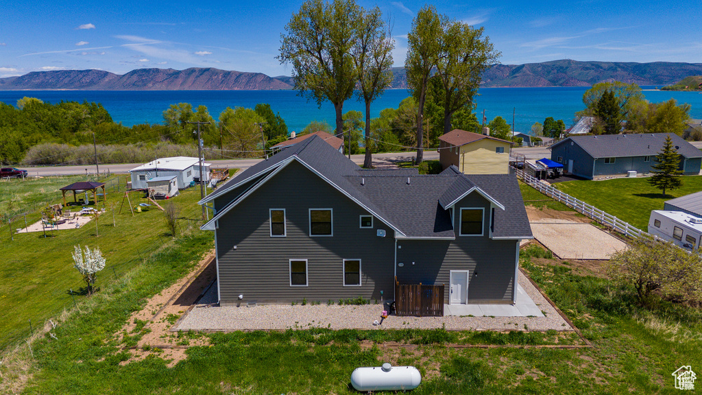 Birds eye view of property with a water and mountain view