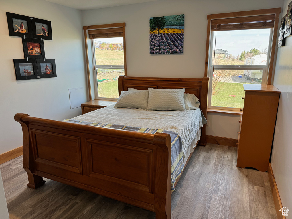 Bedroom featuring baseboards and wood finished floors