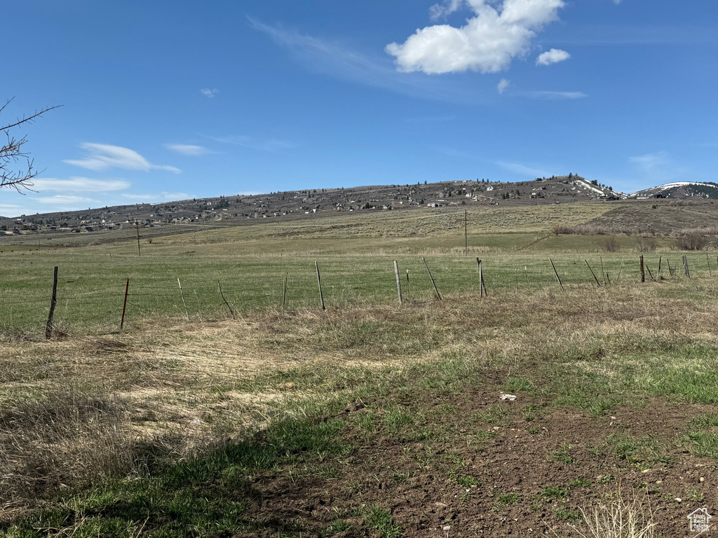 View of yard featuring a rural view and fence