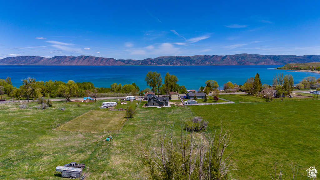 Birds eye view of property with a water and mountain view