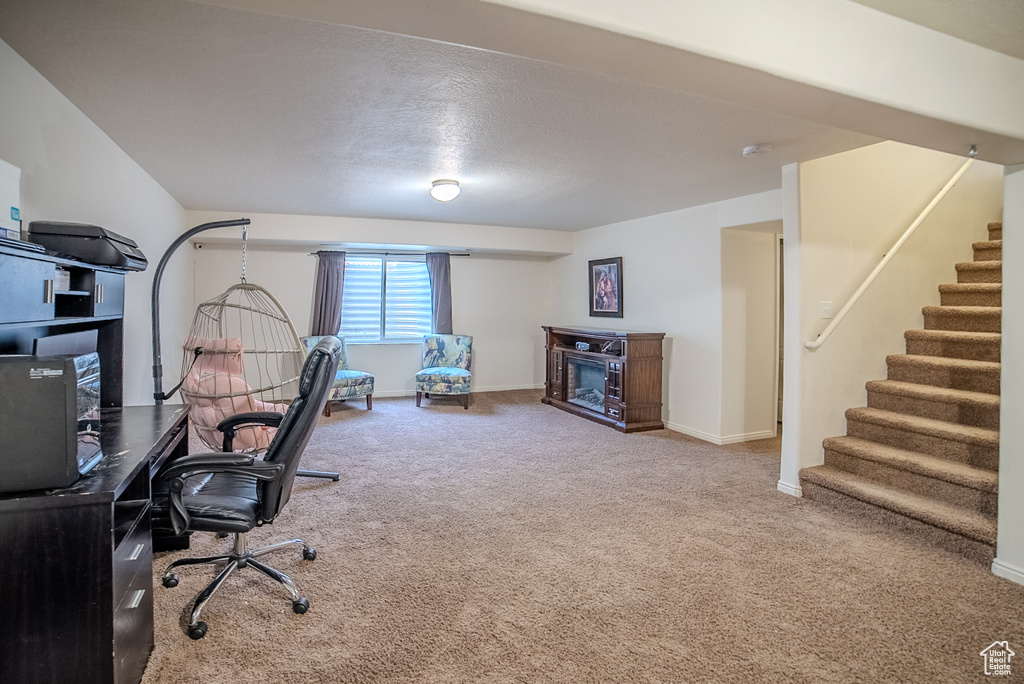 Home office with carpet flooring and baseboards