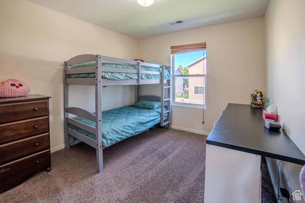 Bedroom featuring carpet floors and baseboards