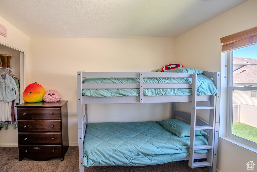 Carpeted bedroom with baseboards