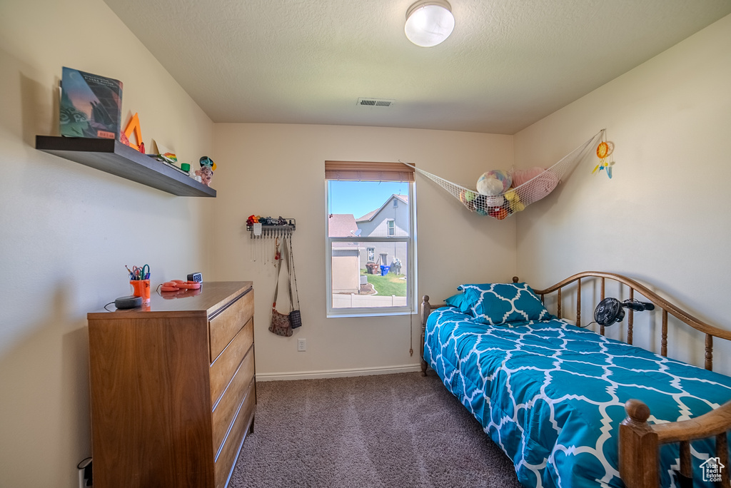 Carpeted bedroom with baseboards