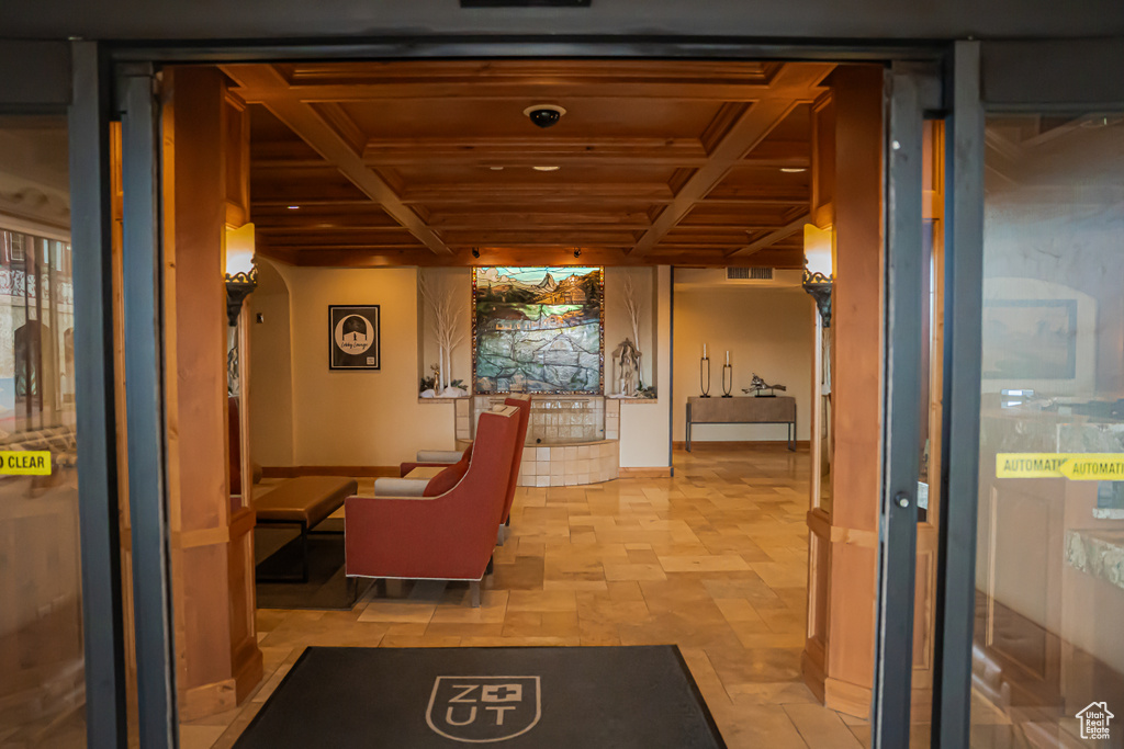 Hall featuring wood ceiling, coffered ceiling, and beamed ceiling