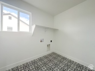 Laundry room with tile patterned floors, hookup for an electric dryer, washer hookup, and baseboards