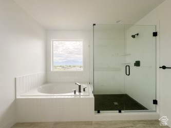 Bathroom featuring a stall shower, a bath, and tile patterned floors