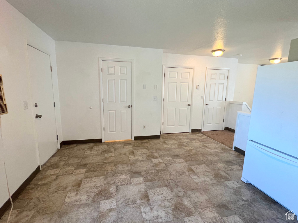 Unfurnished room with stone finish floor and baseboards