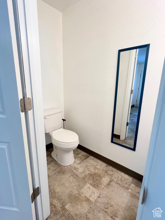 Bathroom featuring toilet and baseboards