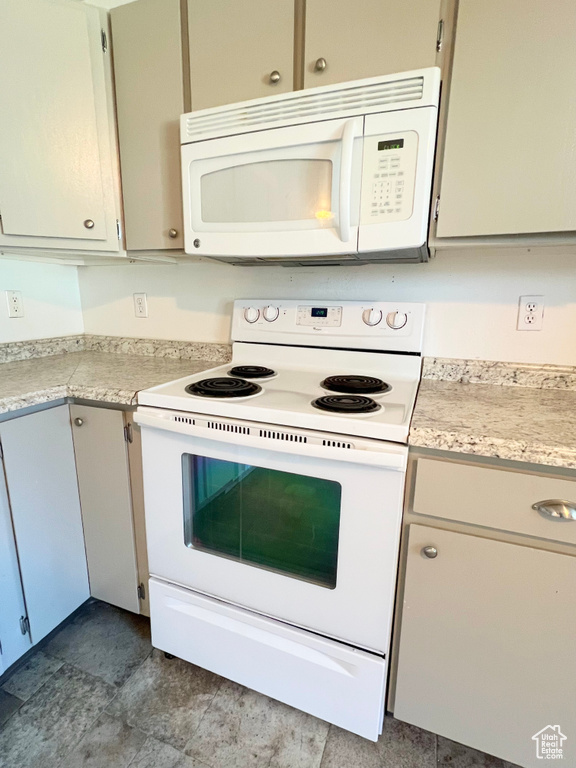 Kitchen with white appliances and light countertops