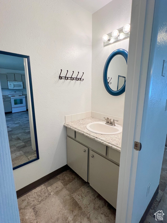 Bathroom with vanity and baseboards