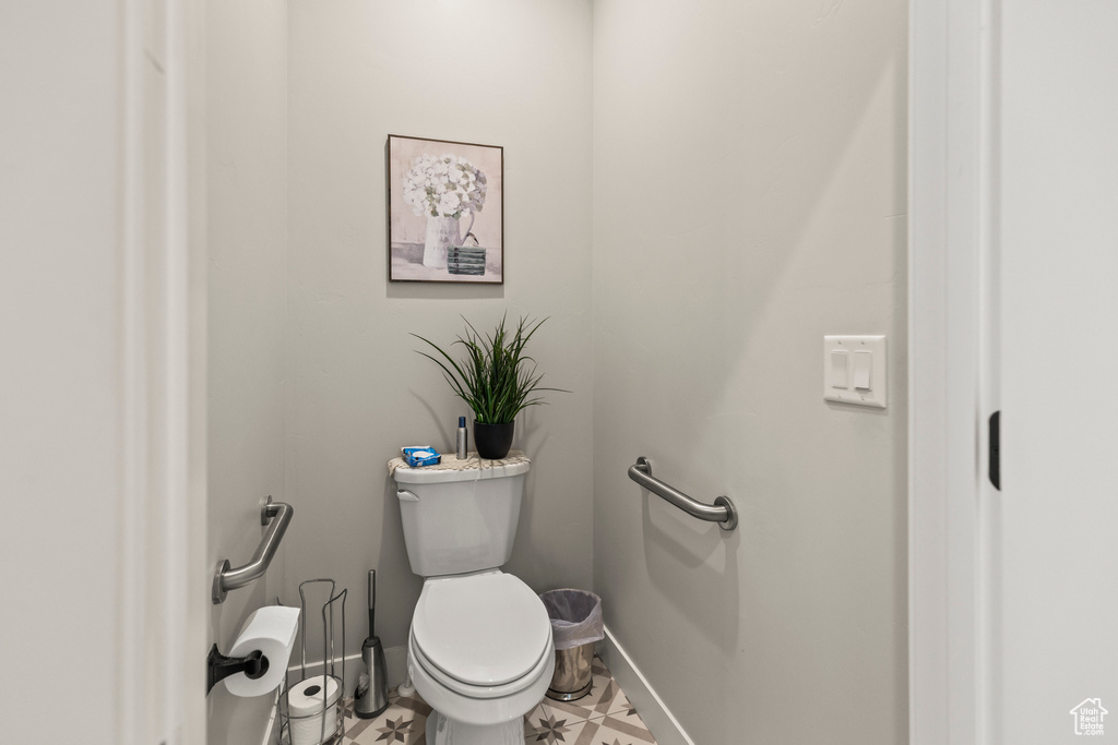 Bathroom featuring baseboards and toilet