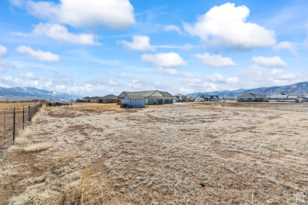 View of yard with fence and a mountain view