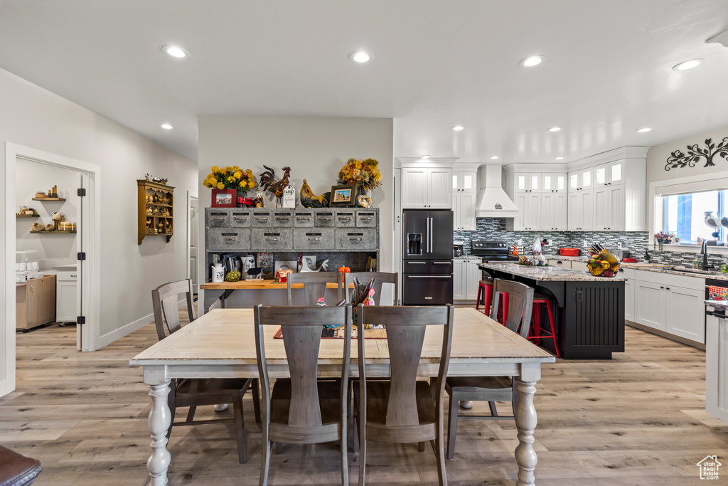 Dining space featuring baseboards, recessed lighting, and light wood-style floors