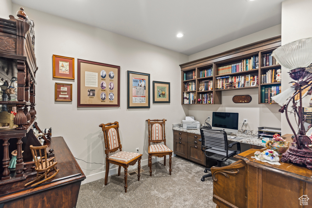 Office area with carpet floors, built in desk, recessed lighting, and baseboards