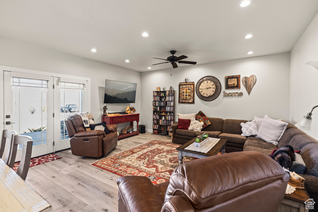 Living area with light wood finished floors, a ceiling fan, and recessed lighting