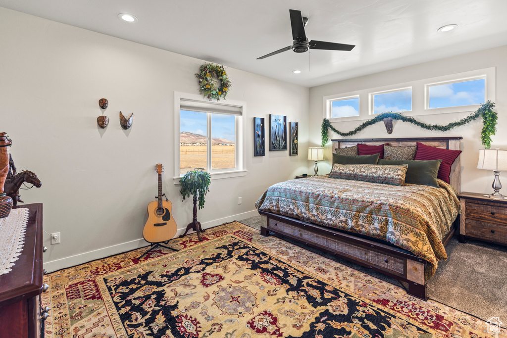 Bedroom with a ceiling fan, recessed lighting, and baseboards