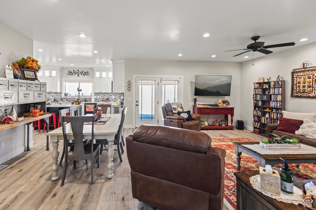 Living area featuring light wood finished floors, baseboards, a ceiling fan, and recessed lighting