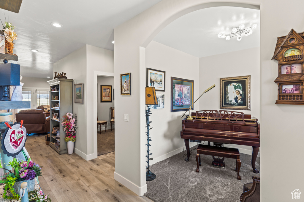 Sitting room with baseboards, arched walkways, hardwood / wood-style floors, and recessed lighting