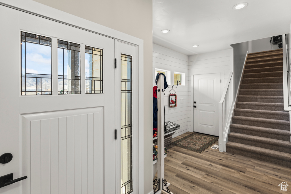 Entrance foyer featuring stairs, recessed lighting, and wood finished floors