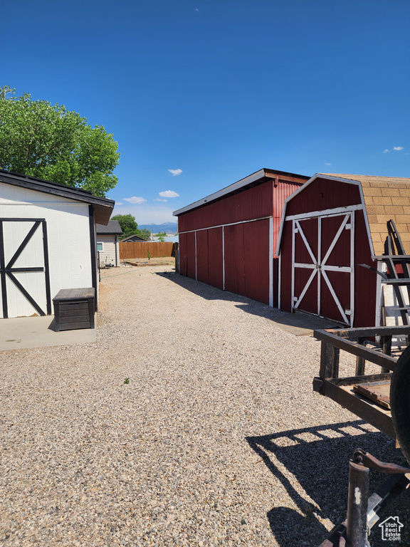 View of outbuilding featuring fence and an outbuilding