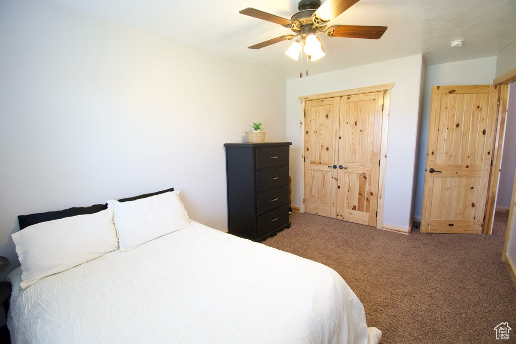 Carpeted bedroom with ceiling fan
