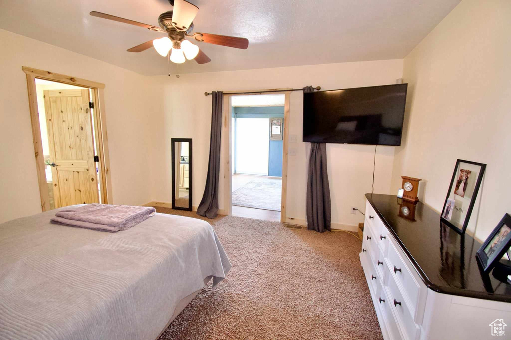 Bedroom with light colored carpet and ceiling fan