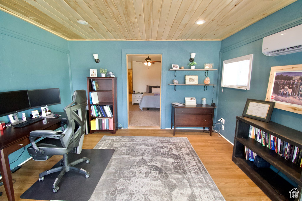 Office space with light wood-style floors, wood ceiling, ceiling fan, and a wall mounted AC