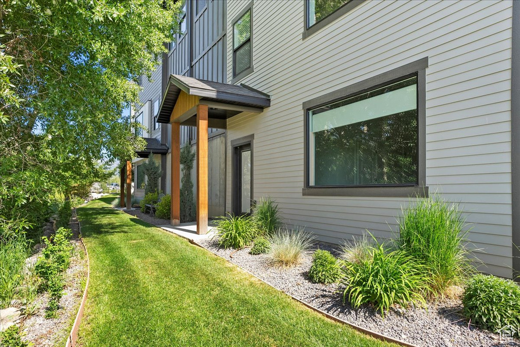 View of side of home featuring a lawn