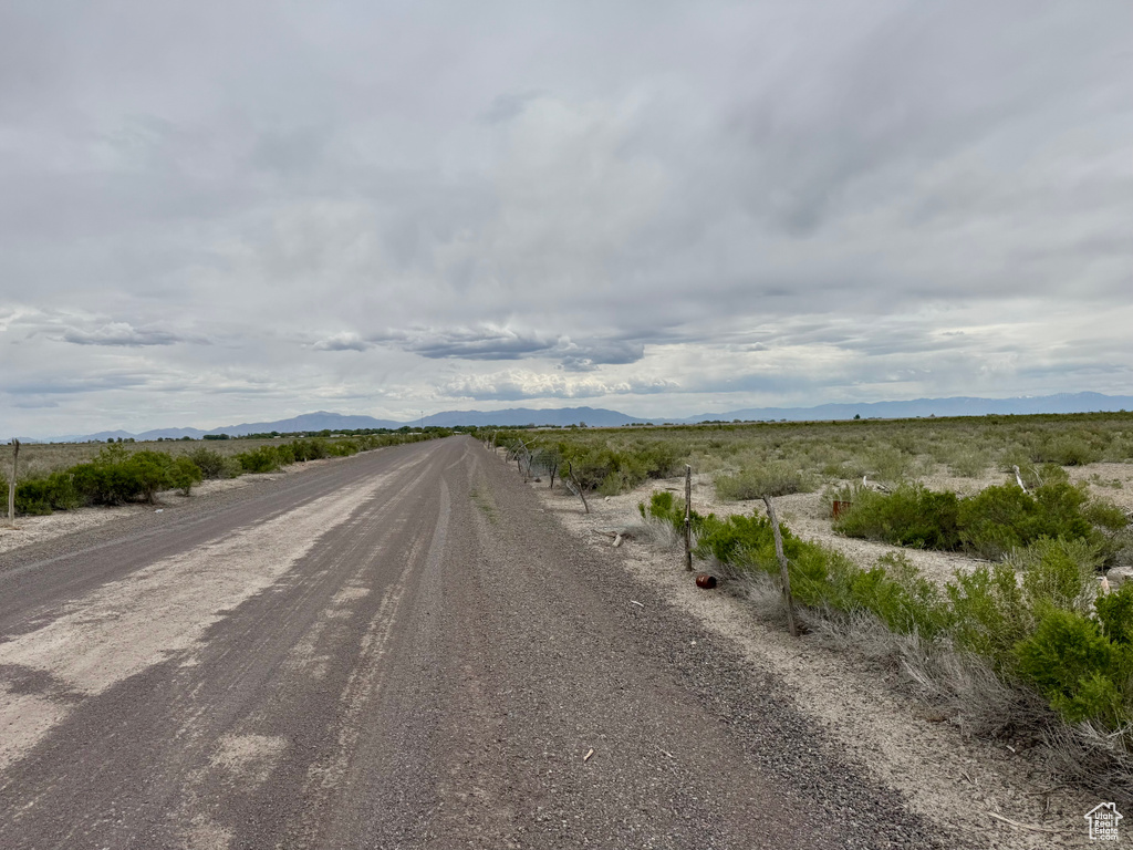 View of dirt / gravel road featuring a mountain view