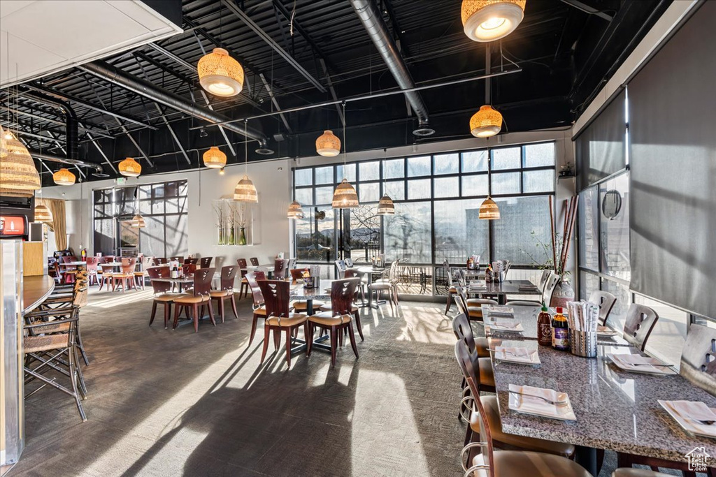 Dining area with carpet floors and plenty of natural light