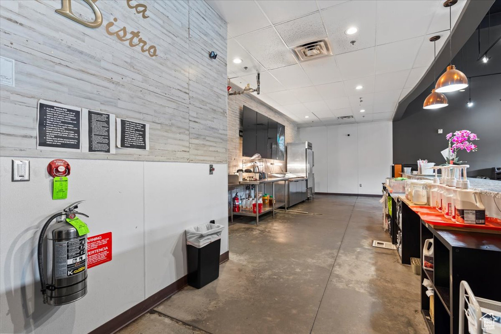 Miscellaneous room featuring visible vents, a drop ceiling, concrete flooring, and recessed lighting