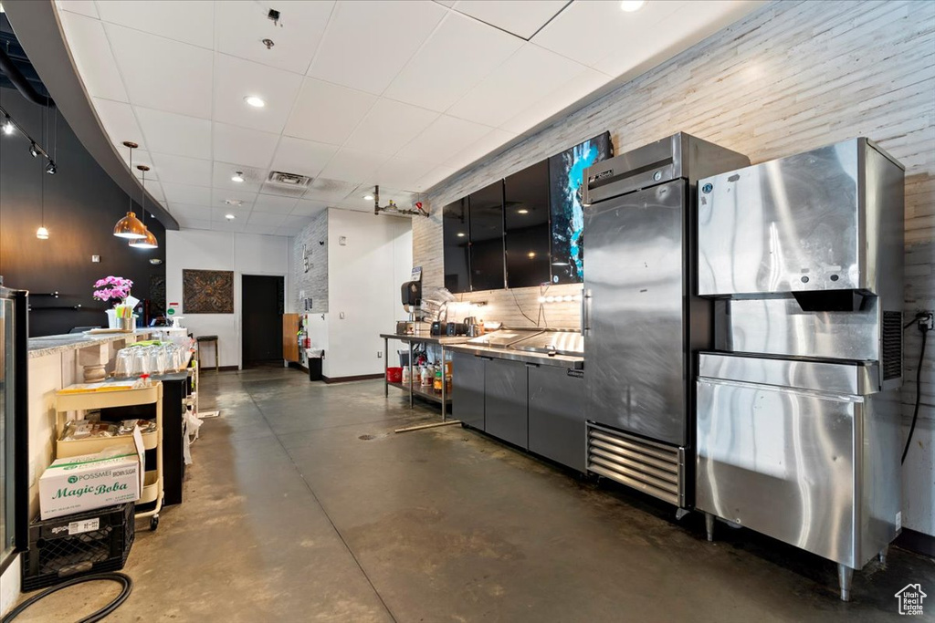 Misc room with finished concrete floors, a paneled ceiling, and visible vents