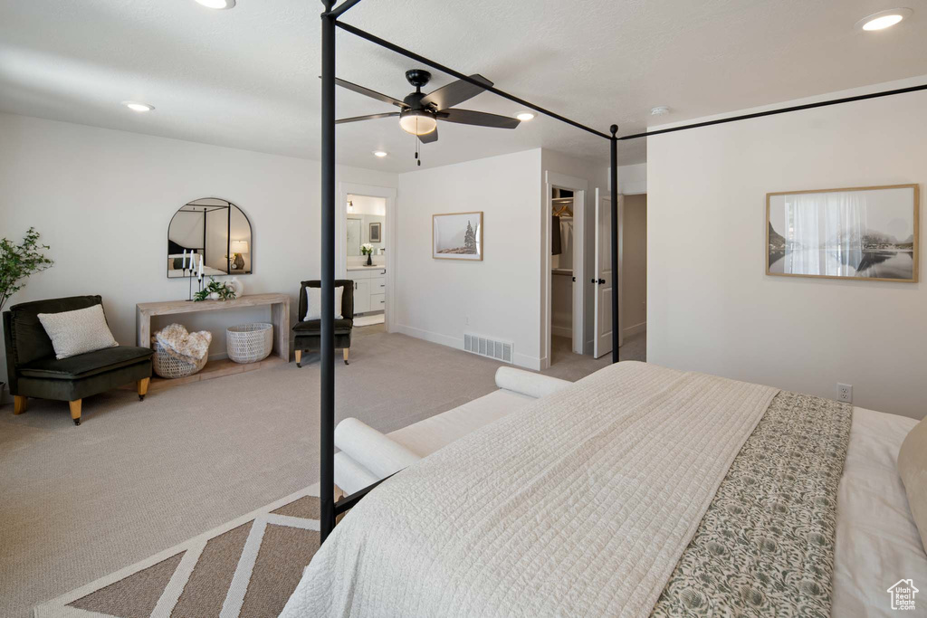 Bedroom with ceiling fan, recessed lighting, light carpet, visible vents, and a spacious closet
