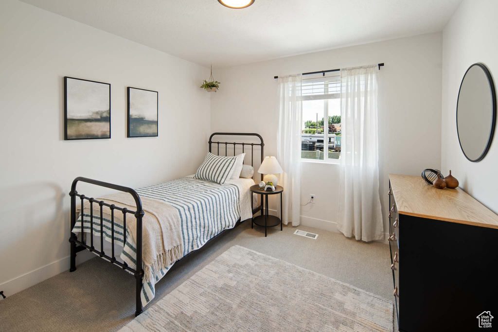 Bedroom with carpet, visible vents, and baseboards