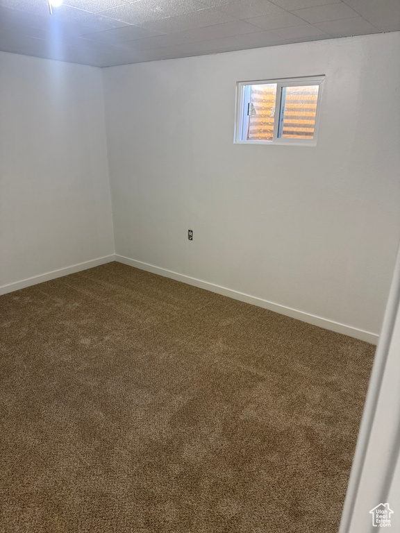 Carpeted empty room with baseboards