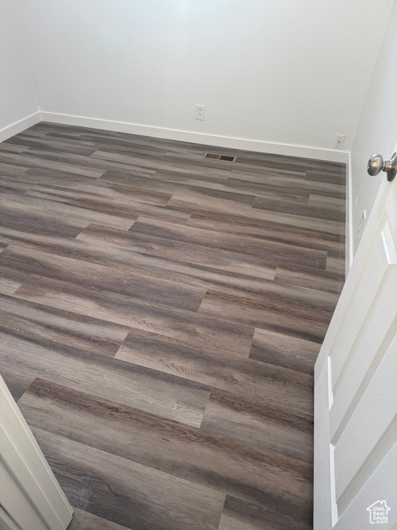 Details featuring wood finished floors, visible vents, and baseboards