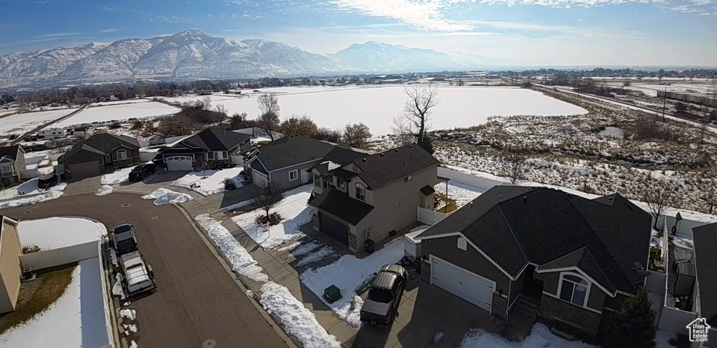 Snowy aerial view with a residential view and a mountain view