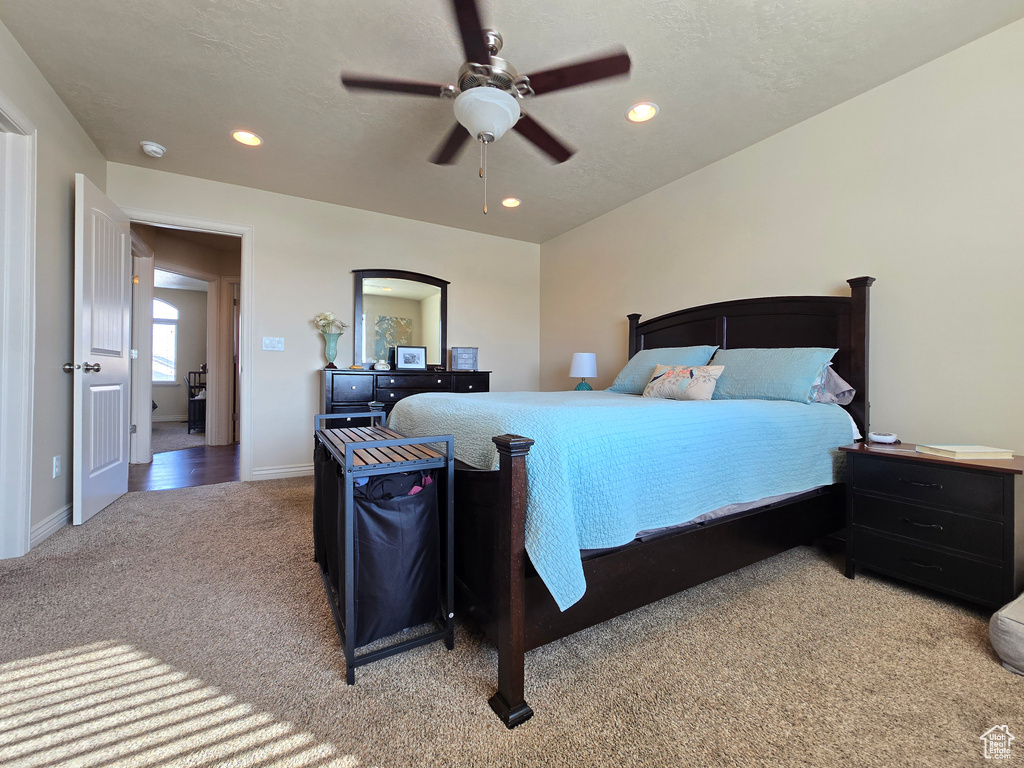 Bedroom with baseboards, a textured ceiling, recessed lighting, and light colored carpet