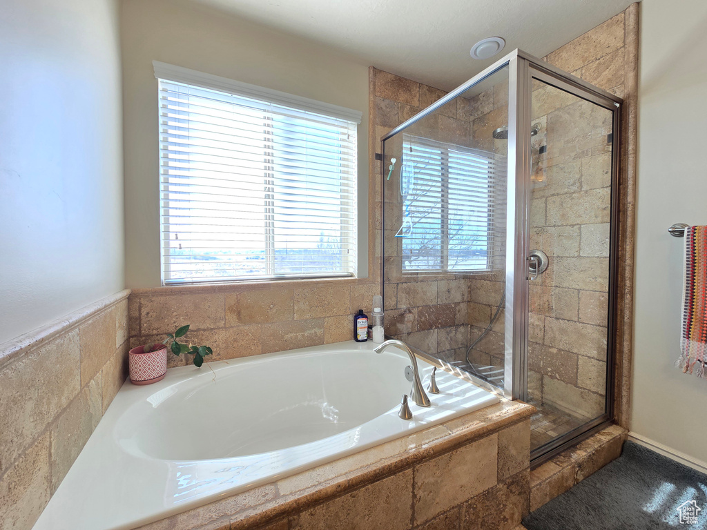 Full bath with a stall shower and a garden tub