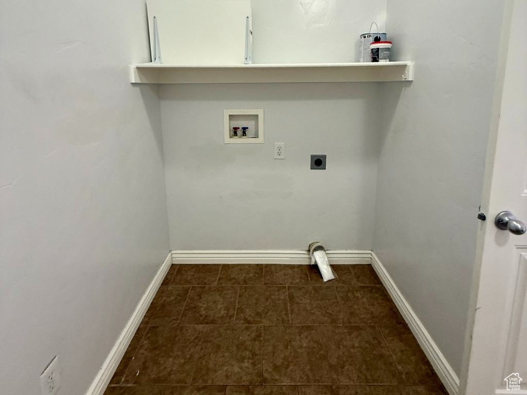 Clothes washing area featuring electric dryer hookup, baseboards, washer hookup, and laundry area