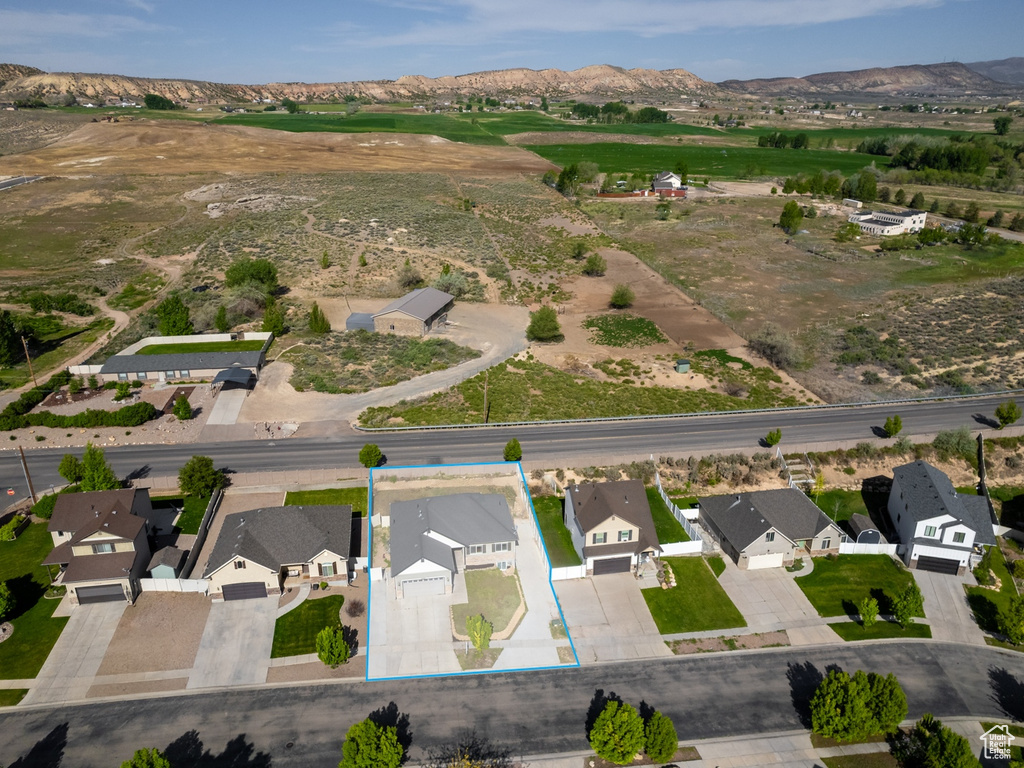 Aerial view of residential area featuring property parcel outlined and mountains