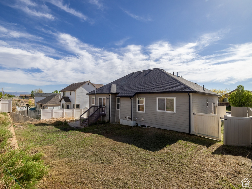 Rear view of property with roof with shingles