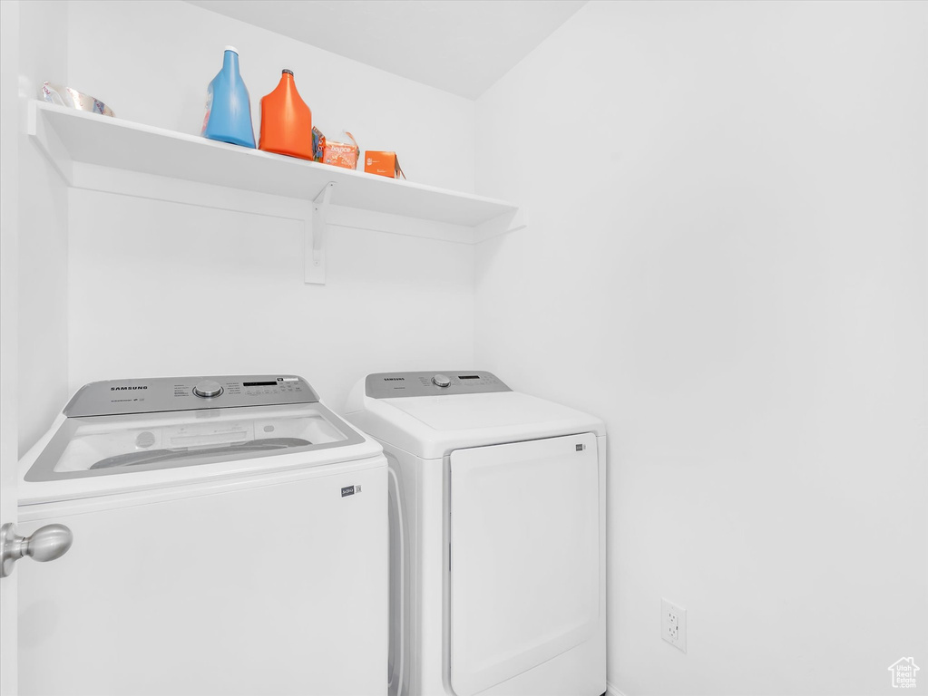 Washroom with laundry area and washing machine and clothes dryer