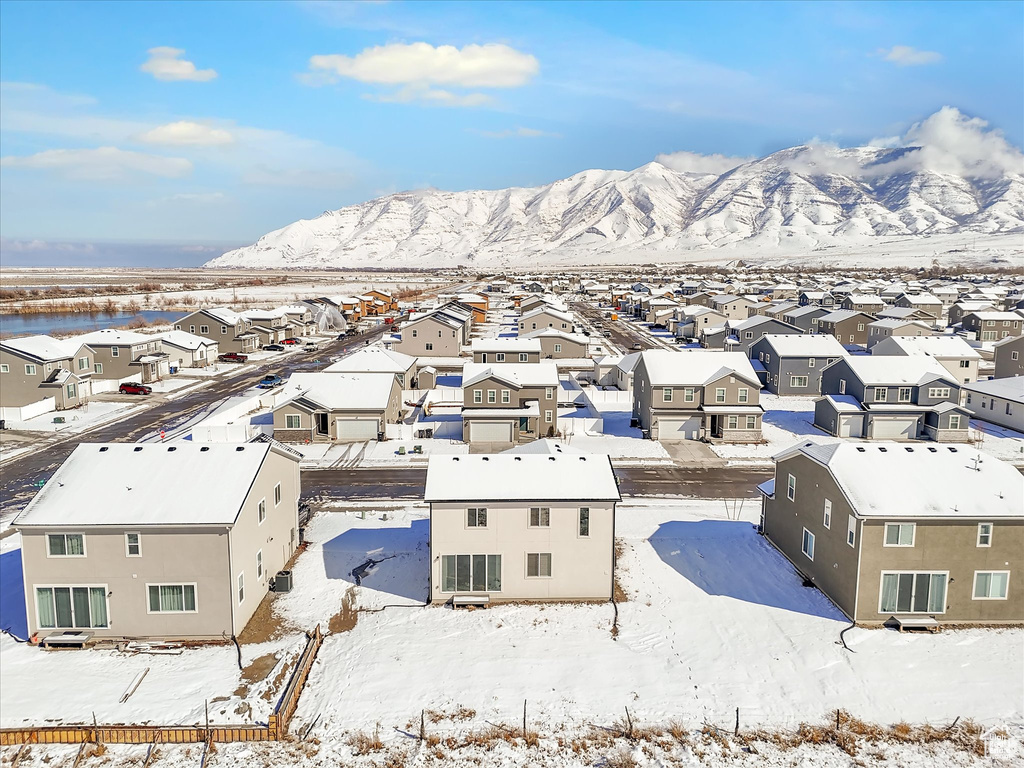 Snowy aerial view with a residential view and a mountain view