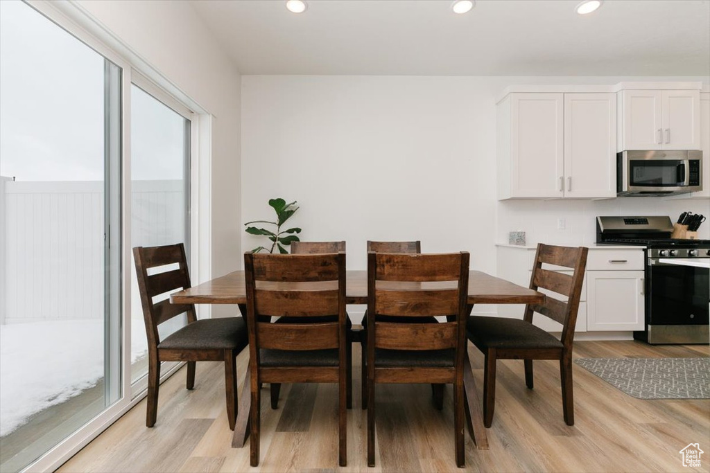 Dining area with light hardwood / wood-style floors