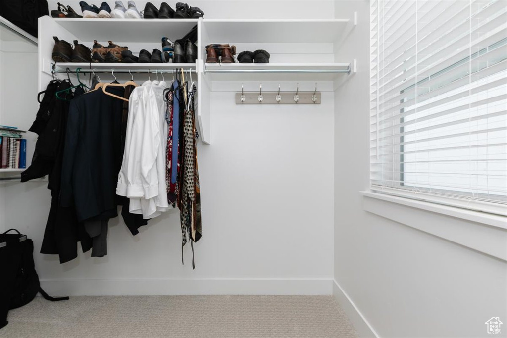 Walk in closet featuring carpet flooring