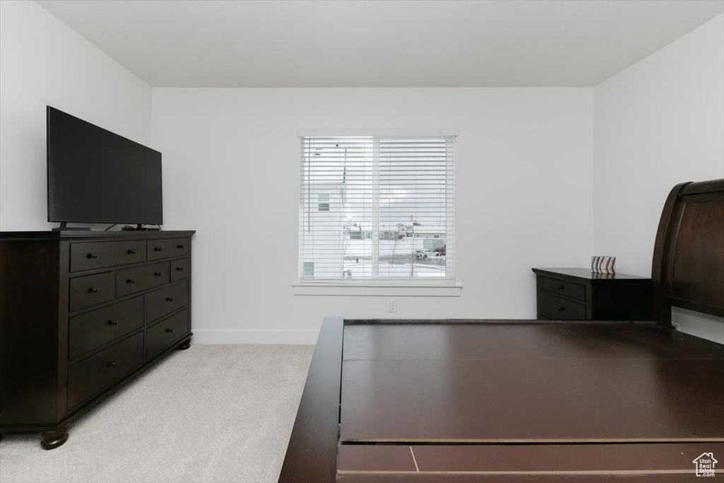 Bedroom featuring light colored carpet