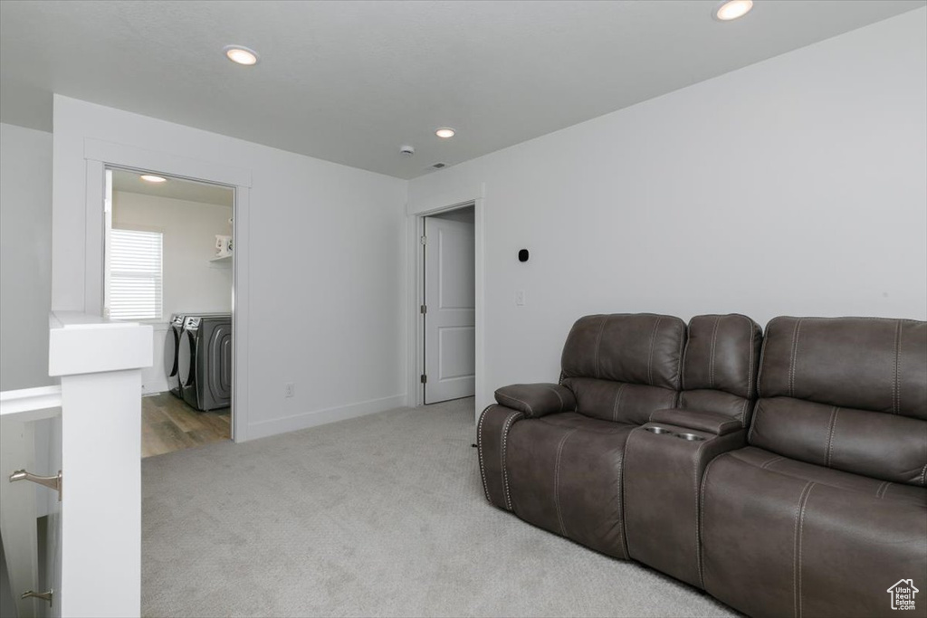 Carpeted living room with washer and dryer