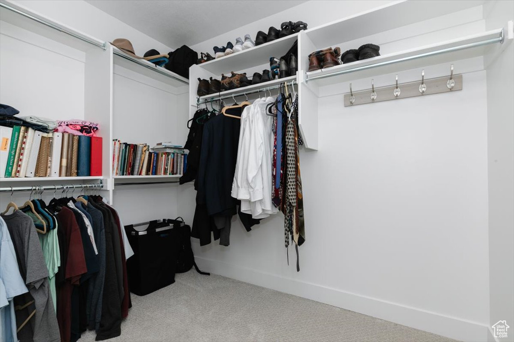 Walk in closet with carpet flooring